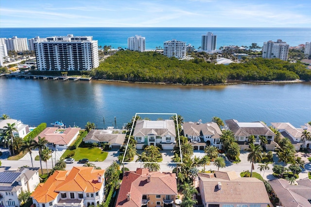 birds eye view of property with a water view and a residential view