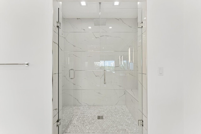 bathroom with a marble finish shower