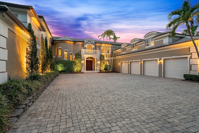 65 S River Rd, Sewalls Point, FL 34996 - view of front of home with stucco siding, decorative driveway, and a balcony
