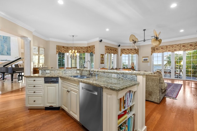 kitchen with dishwasher, ornamental molding, light wood-type flooring, and a sink