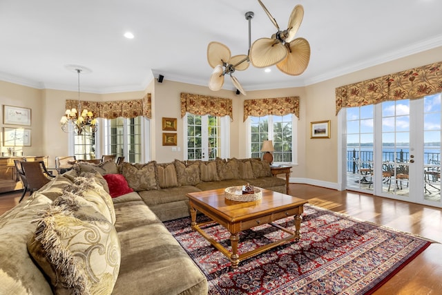 living room featuring crown molding, recessed lighting, wood finished floors, baseboards, and ceiling fan with notable chandelier