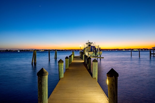 dock area with a water view and boat lift