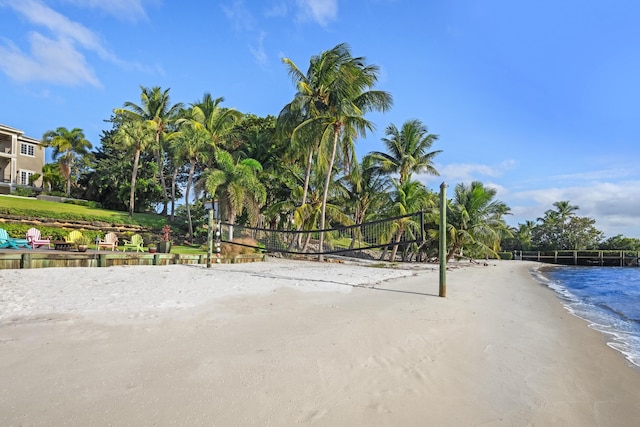 view of community featuring volleyball court and a water view