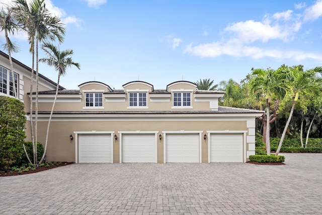 garage with decorative driveway