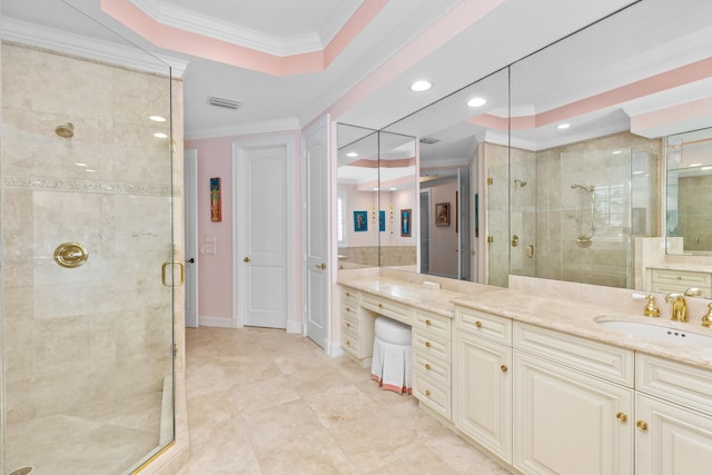 full bath with a stall shower, ornamental molding, a raised ceiling, and vanity