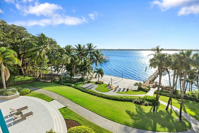 view of home's community featuring a lawn and a water view