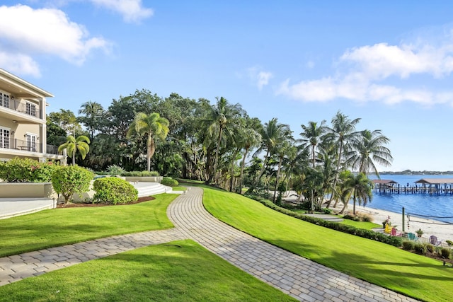 view of home's community featuring a water view and a lawn