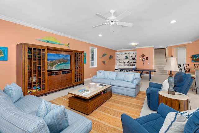 living area with ceiling fan, wood finished floors, crown molding, and recessed lighting