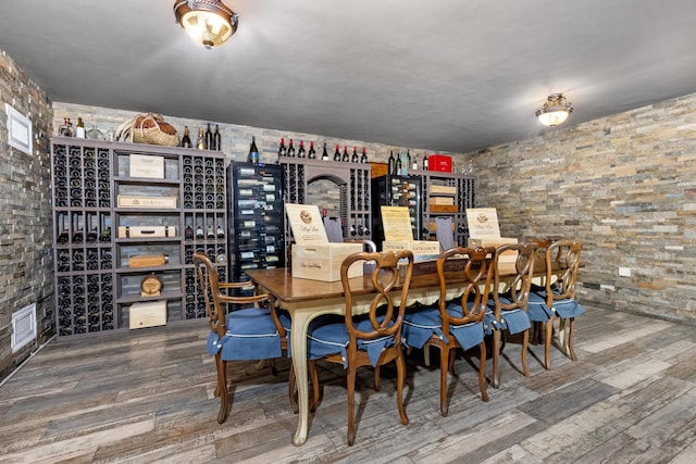 wine area with wood finished floors and visible vents