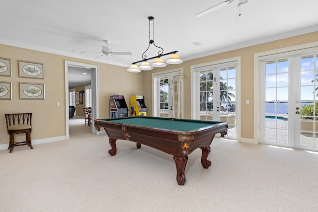 game room with a ceiling fan, french doors, light colored carpet, and crown molding