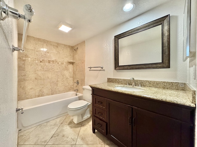 bathroom with a textured wall, toilet, vanity, tile patterned floors, and washtub / shower combination