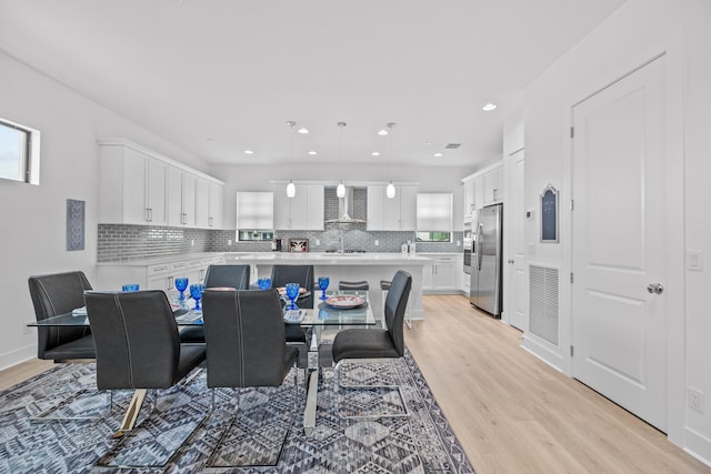 dining room with sink and light wood-type flooring