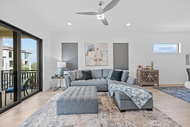 living room featuring ceiling fan and wood-type flooring