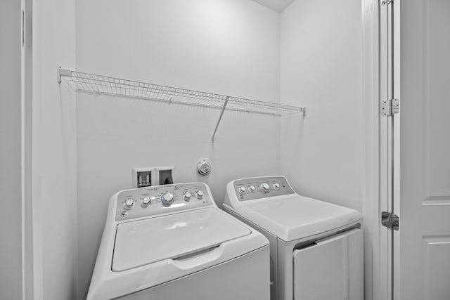 laundry area with washing machine and clothes dryer