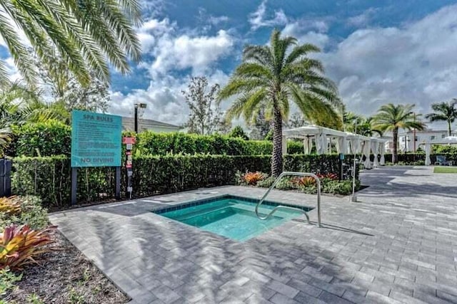 view of swimming pool with a hot tub