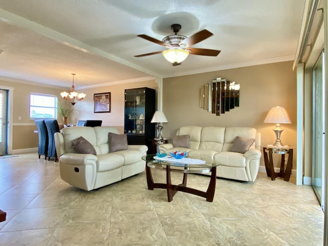 living room featuring ceiling fan with notable chandelier, ornamental molding, and a textured ceiling