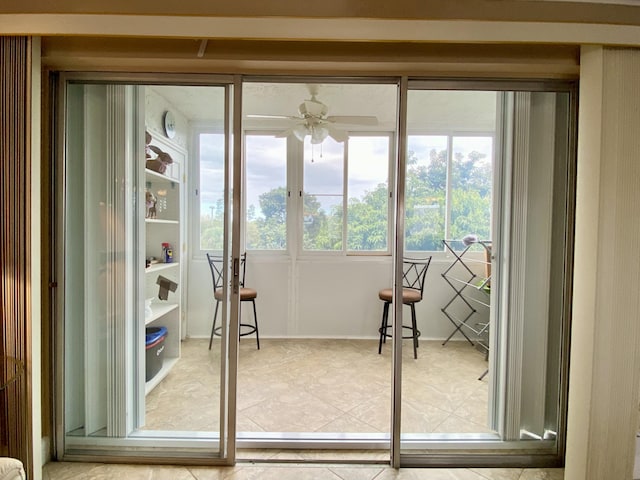 doorway to outside featuring tile patterned flooring and ceiling fan