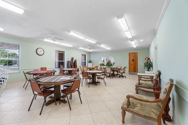 tiled dining area with crown molding and a textured ceiling