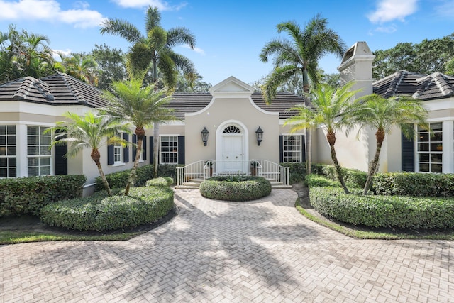 mediterranean / spanish-style house with a tiled roof and stucco siding