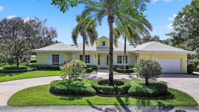 view of front of house with a front yard and a garage