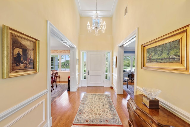 9 Par Club Cir, Village Of Golf, FL 33436 - foyer with a chandelier, a high ceiling, light hardwood / wood-style flooring, and ornamental molding