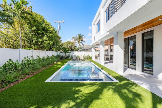 view of swimming pool with a lawn and a patio