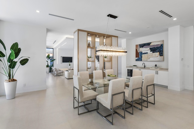 dining space with bar, wine cooler, and a chandelier