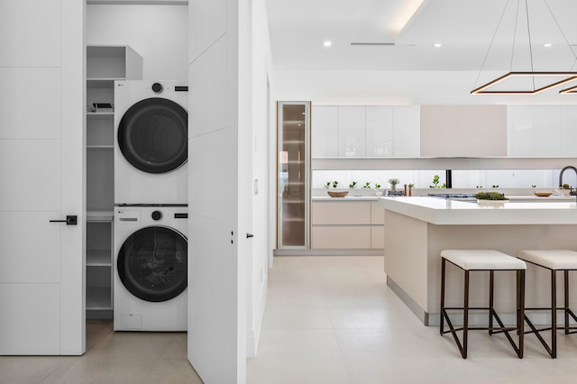 laundry area with stacked washer and dryer