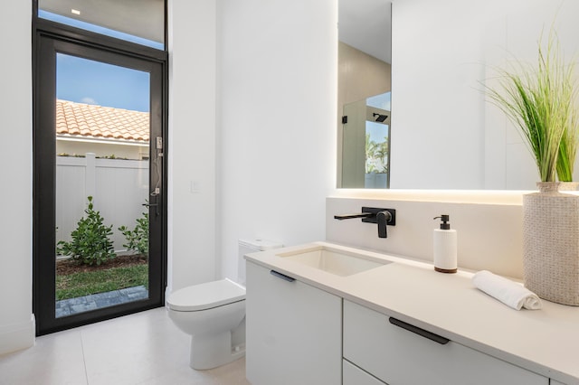 bathroom with vanity, tile patterned floors, and toilet