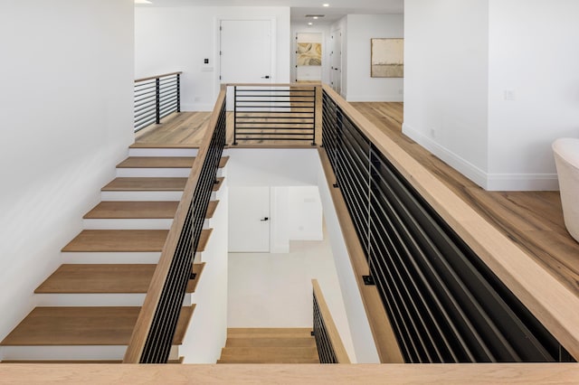 stairway featuring hardwood / wood-style floors