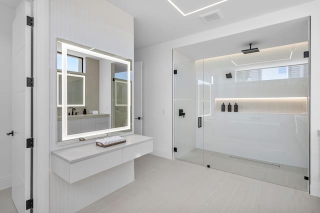 bathroom featuring vanity and a shower with shower door