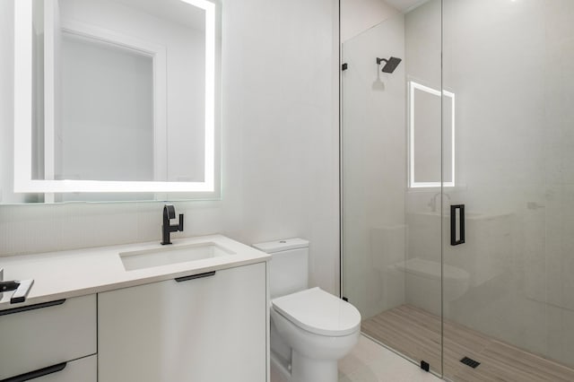 bathroom with walk in shower, vanity, and toilet