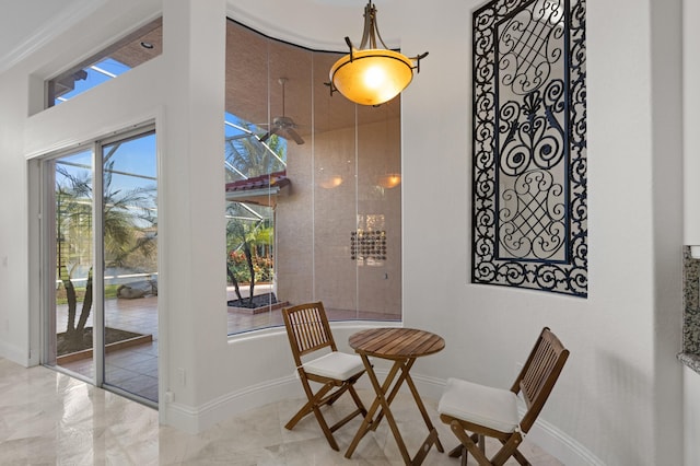 dining space with marble finish floor and baseboards