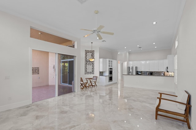 unfurnished living room featuring baseboards, a ceiling fan, a towering ceiling, marble finish floor, and crown molding