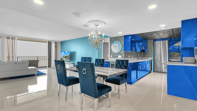 dining area with sink and a notable chandelier