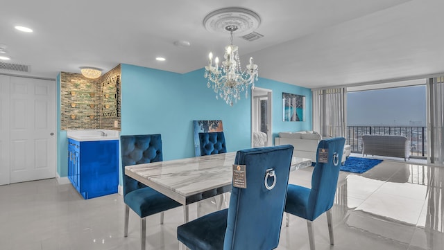 tiled dining area with a chandelier