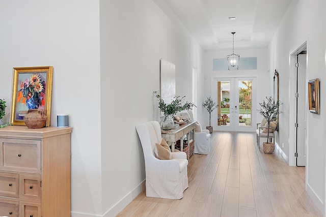 entrance foyer with light hardwood / wood-style flooring and french doors