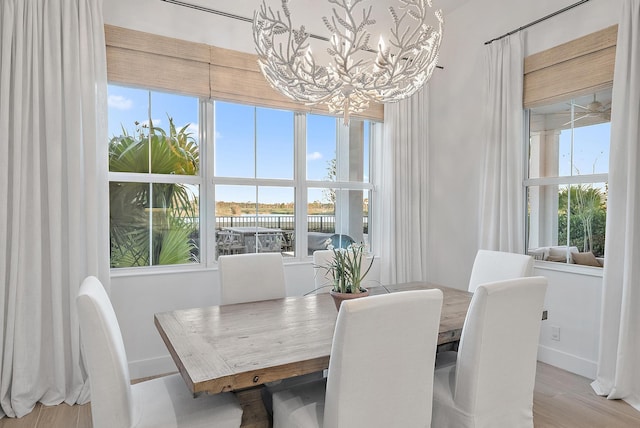 dining area with a chandelier and light hardwood / wood-style floors