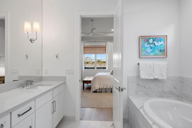 bathroom with vanity and tiled tub