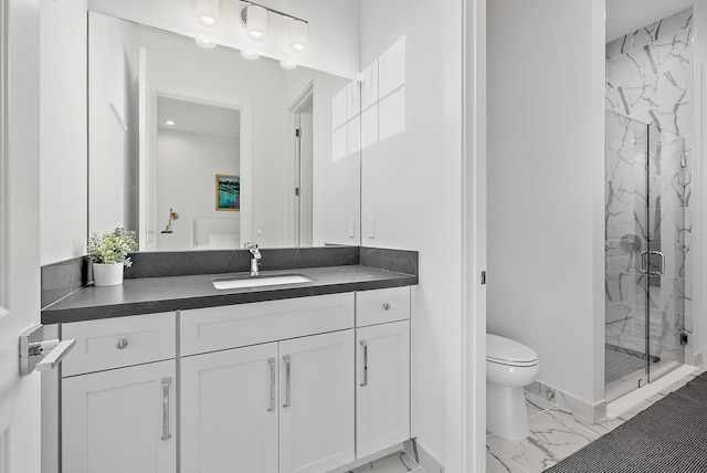 bathroom with vanity, toilet, and an enclosed shower