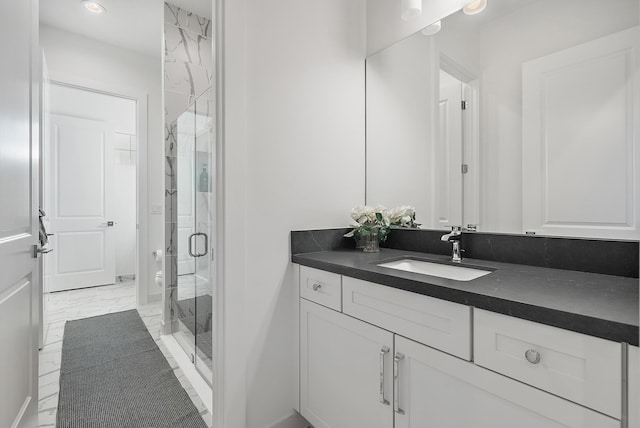 bathroom with walk in shower, vanity, and toilet