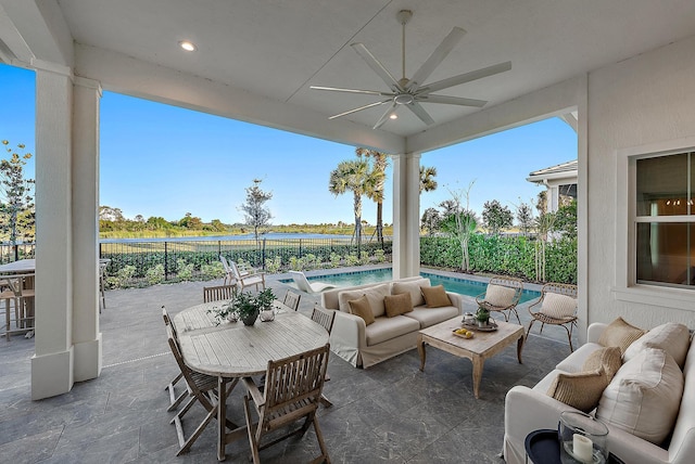 view of patio / terrace with ceiling fan, outdoor lounge area, and a fenced in pool