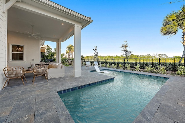 view of pool with pool water feature, ceiling fan, an outdoor hangout area, and a patio