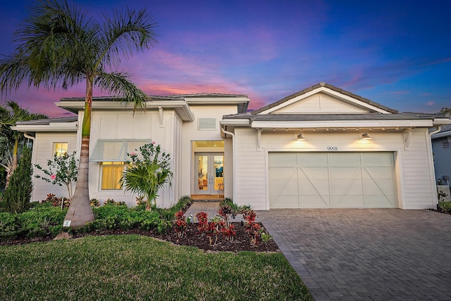 view of front of home featuring french doors and a garage