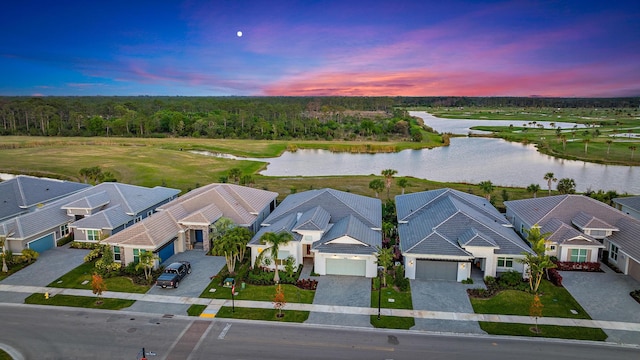 aerial view at dusk with a water view