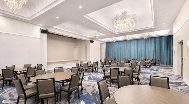 dining area featuring a chandelier and a raised ceiling