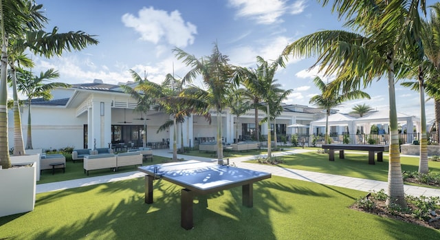 view of property's community with a lawn and outdoor lounge area