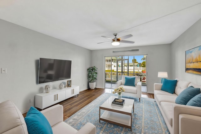 living room with dark hardwood / wood-style floors and ceiling fan