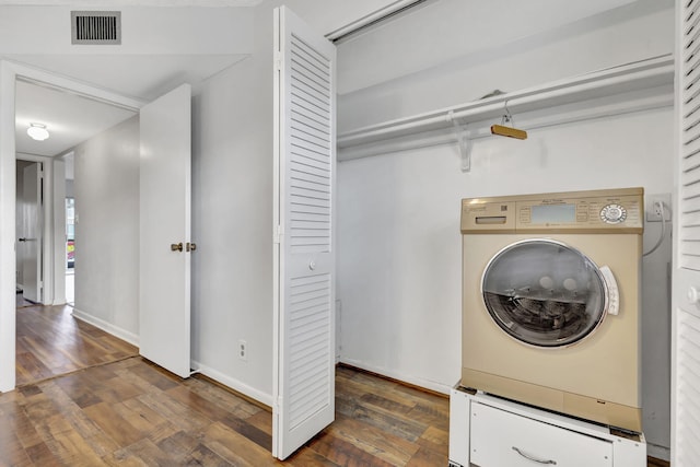 laundry room with dark wood-type flooring