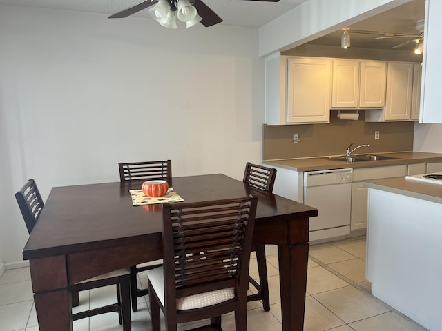 tiled dining room with sink and ceiling fan